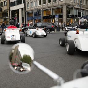 Stag group driving hotrods through scenic Düsseldorf city streets